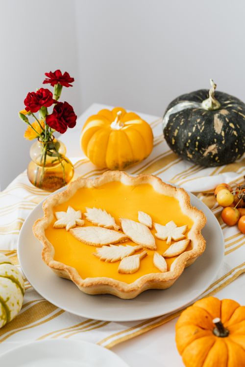 Free A beautifully decorated pumpkin pie with autumn accents and seasonal gourds, perfect for fall celebrations. Stock Photo