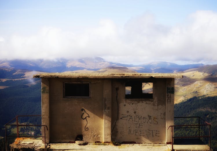 Abandoned Concrete Building With An Overlooking View Of Mountains