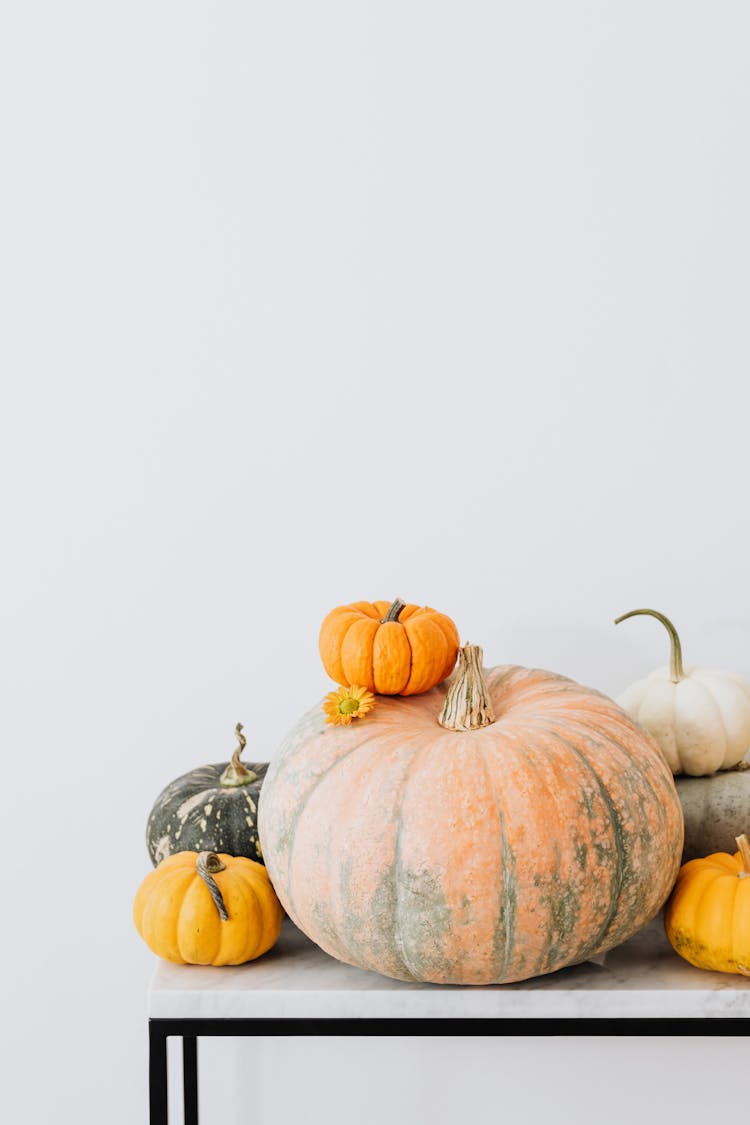 Pumpkins On White Marble Table 