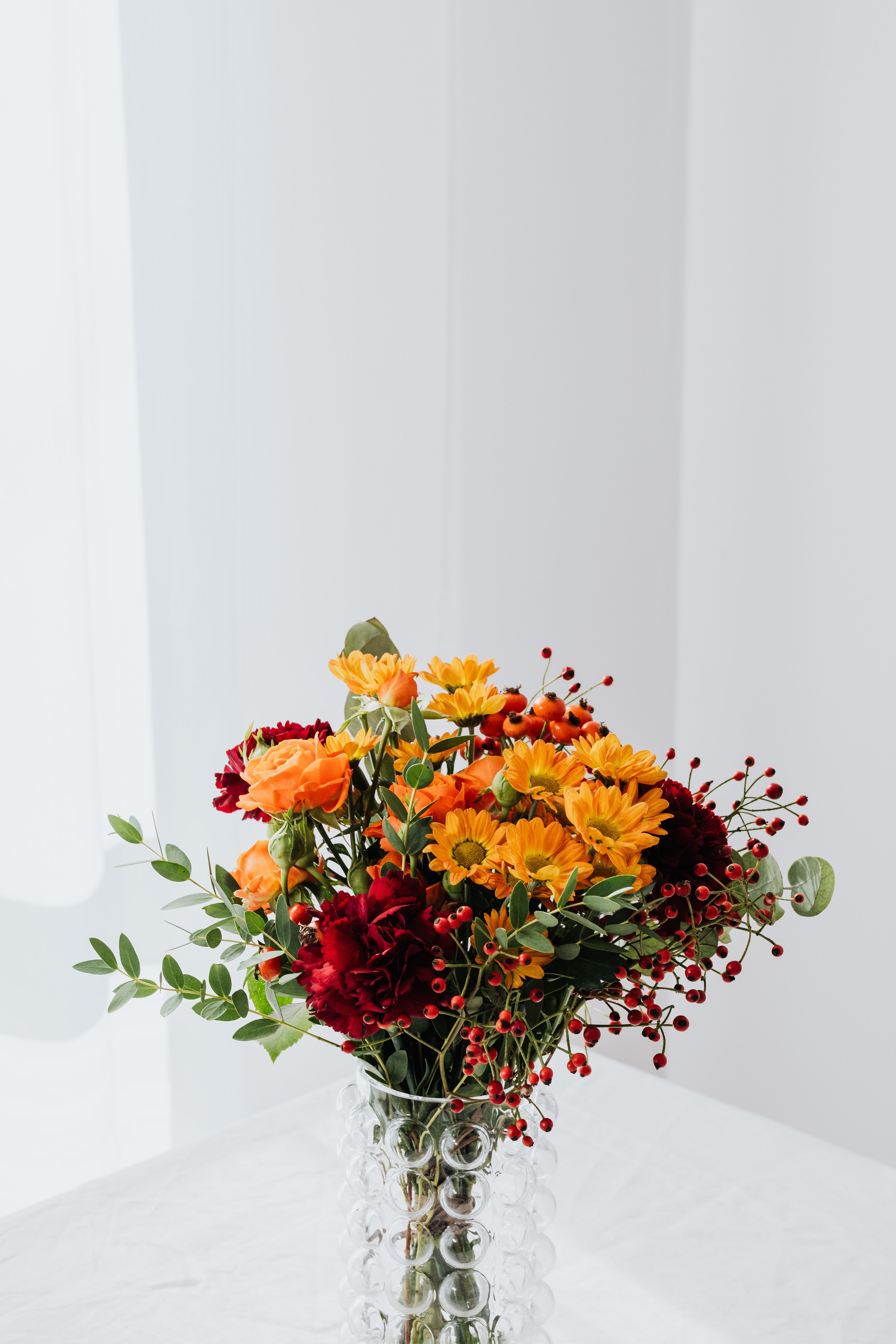 Red and Yellow Flowers in Clear Glass Vase · Free Stock Photo