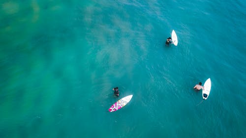 Surfers in clear turquoise lagoon