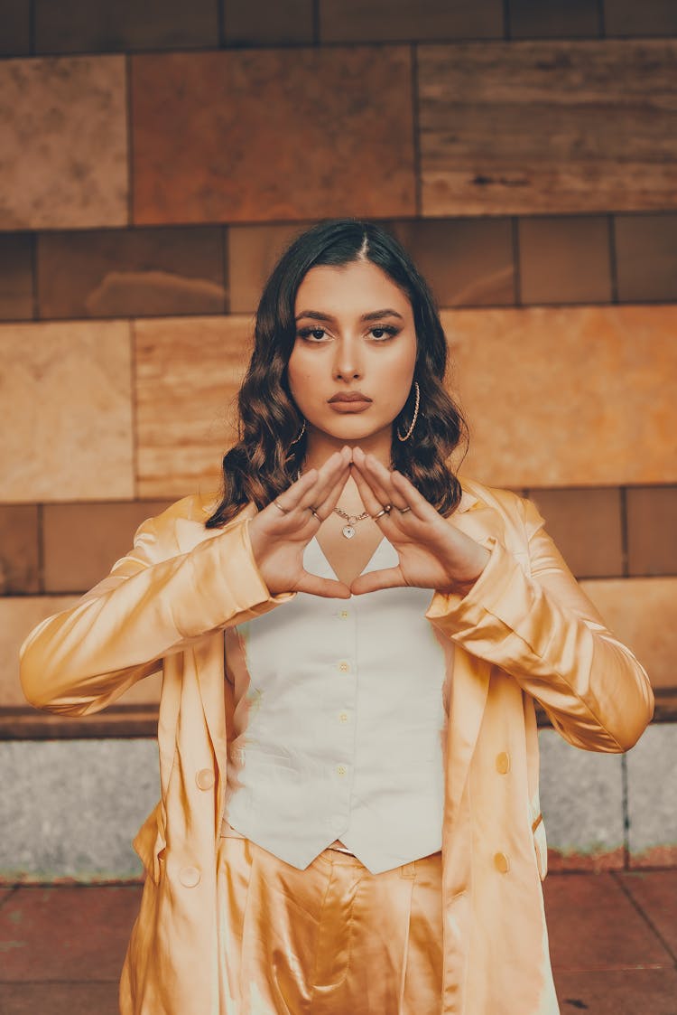 Emotionless Model Showing Illuminati Triangle Gesture