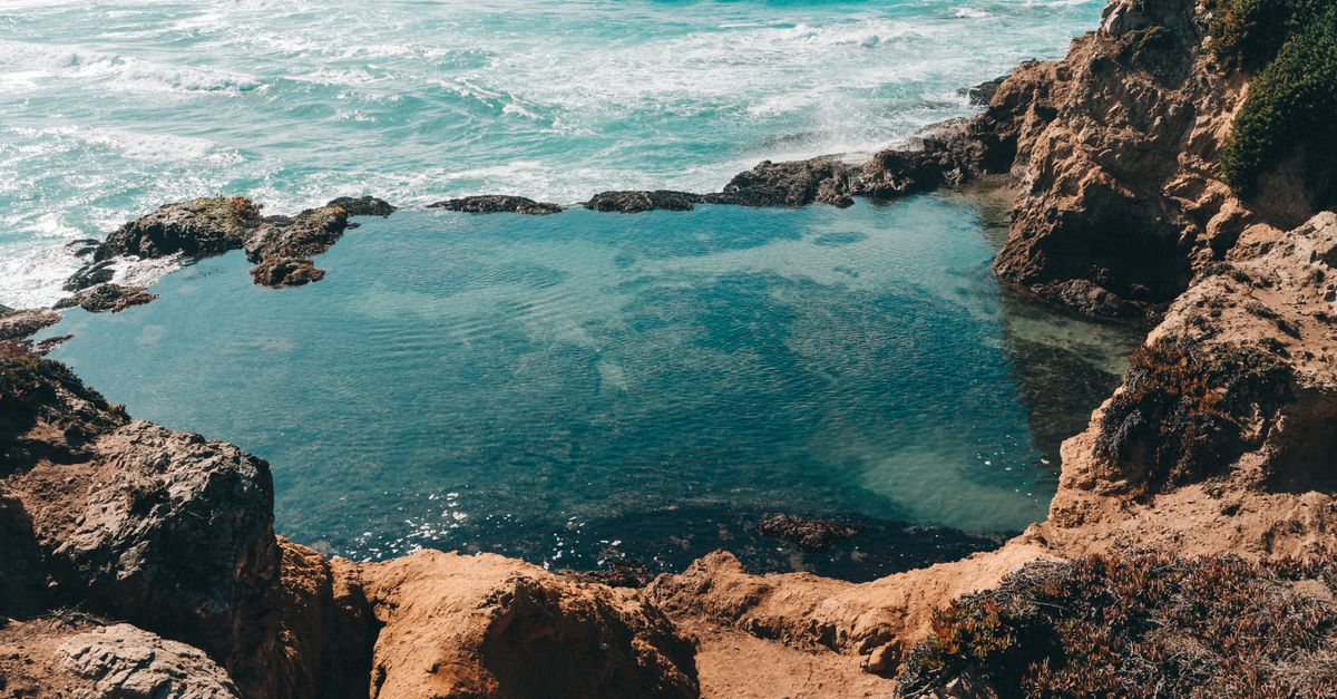 Beautiful view of rocky coastline and natural pool in Fort Bragg, California.