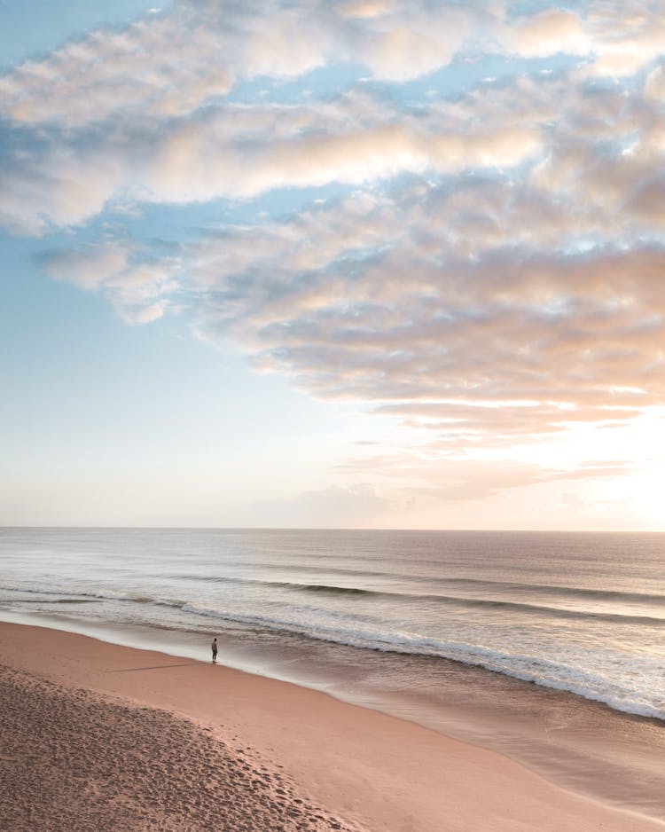 Lonely Person Standing On Sandy Beach