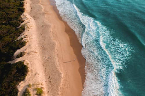 Turquoise water of sea washing sandy shore