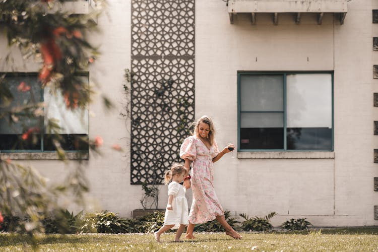 Happy Mother On Lawn With Daughter