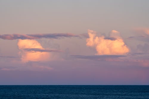 White clouds over calm sea