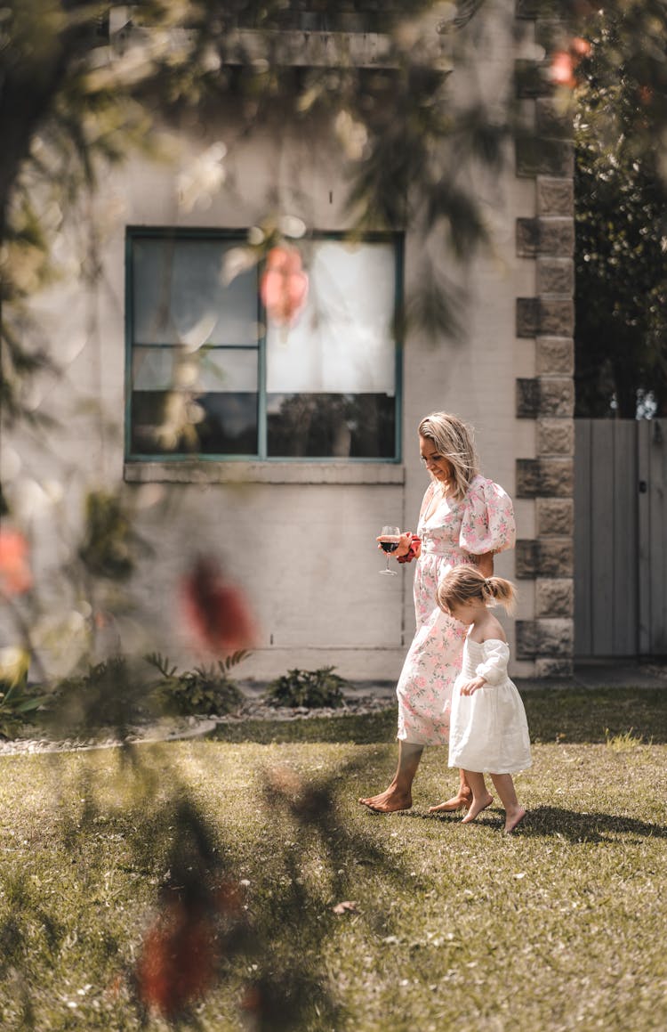 Barefoot Mother And Daughter On Terrace