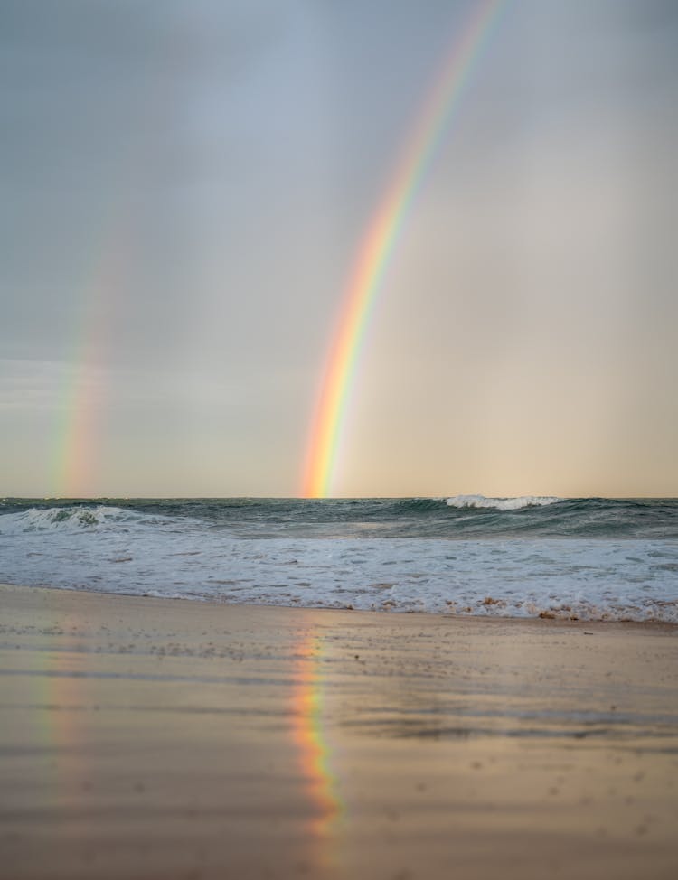 Rainbow Over Waving Sea In Nature