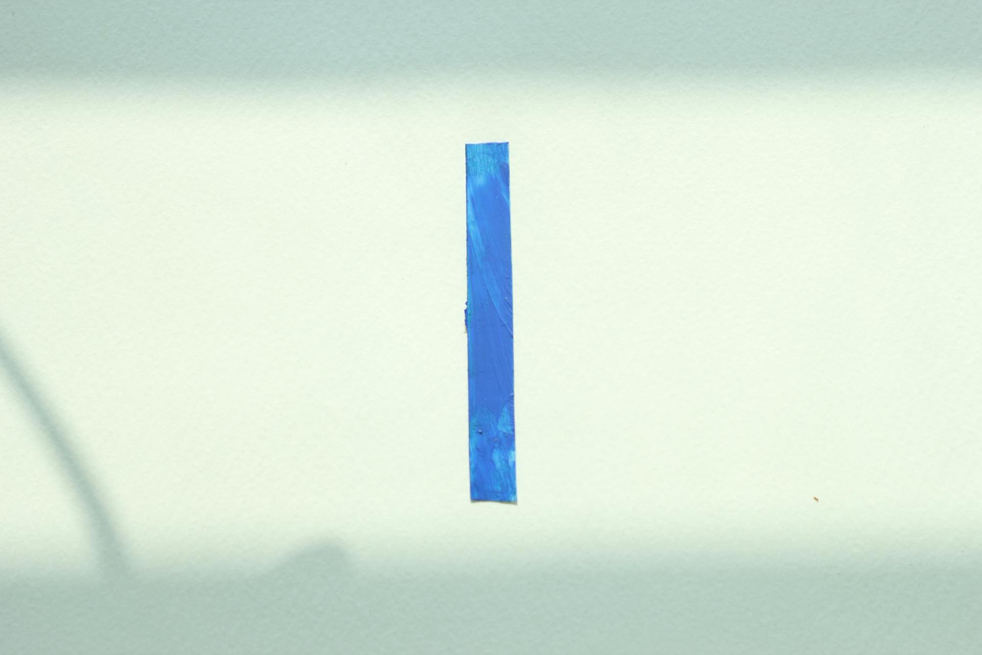 Minimalist art featuring a blue line on a white background, showcasing simplicity.