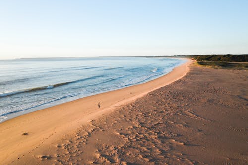 Traveler walking near rippling sea