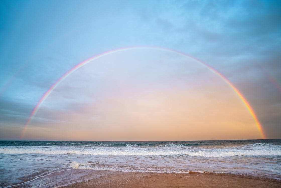 Rainbow over rippling sea in nature