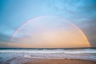 Rainbow over rippling sea in nature