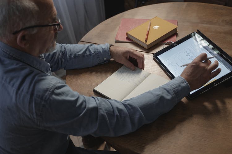 An Elderly Man Using A Tablet