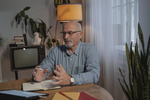 An Elderly Man Talking while Wearing Eyeglasses