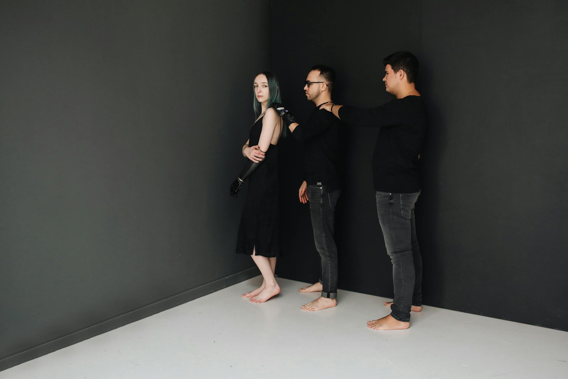 Studio portrait of diverse adults including a woman with a prosthetic arm, highlighting inclusivity and disability awareness.