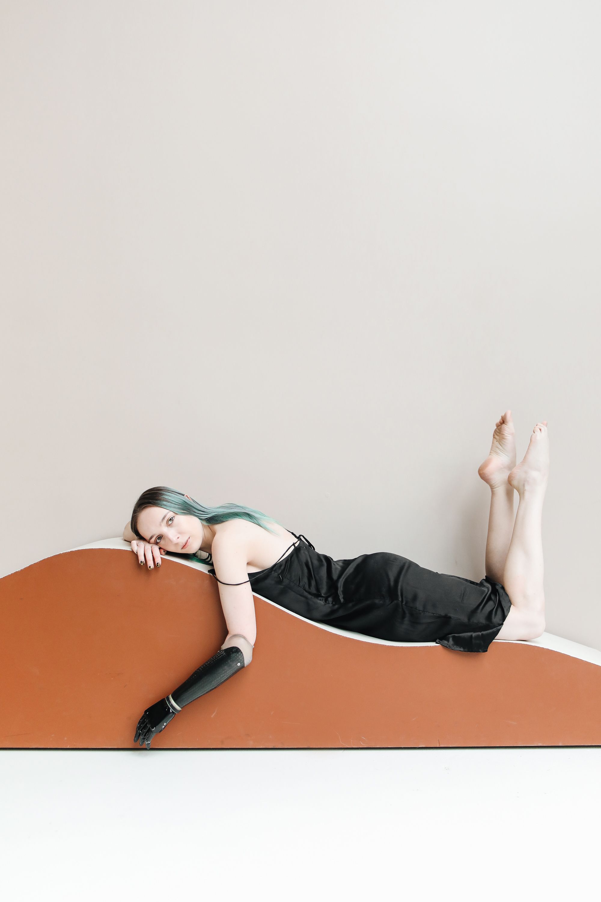 A Woman in a Black Dress Lying on a Wooden Surface · Free Stock Photo