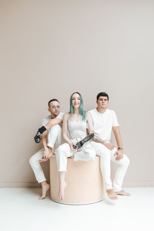 Free Fashionable trio with prosthetic limbs showcasing diversity and empowerment. Stock Photo