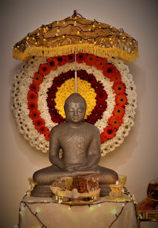Gold Buddha Statue With Red and White Round Decor