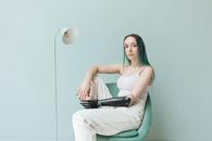 Woman  Sitting on Chair Near a Stand Lamp