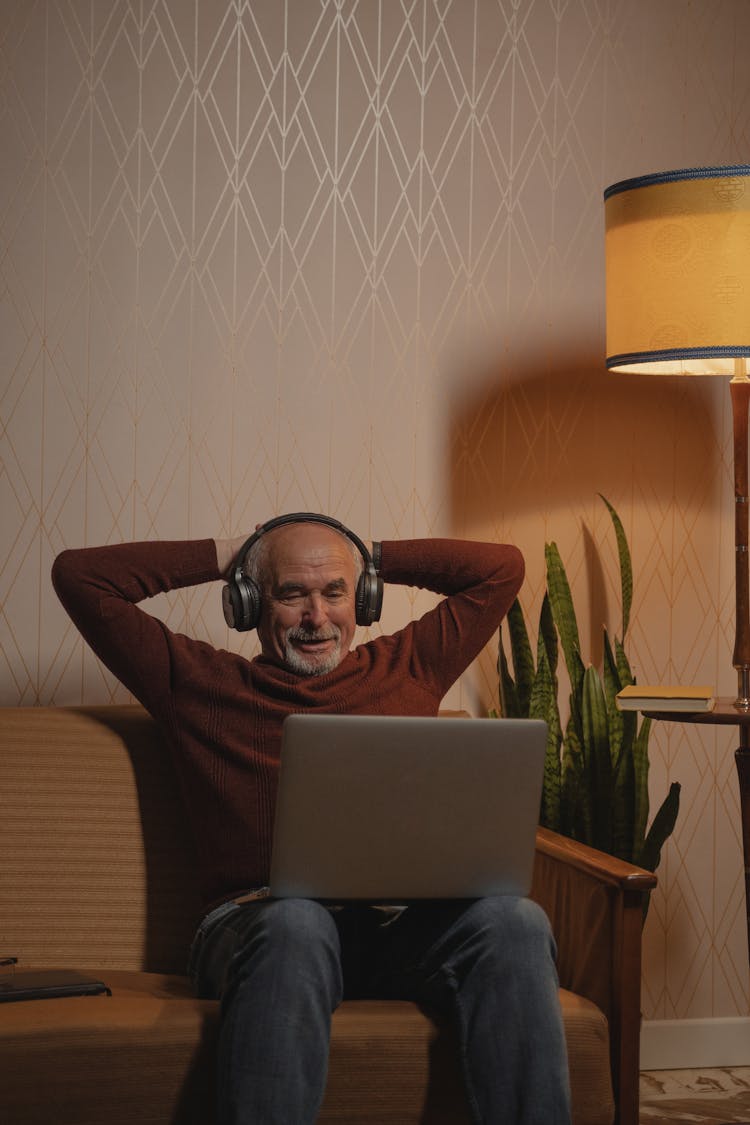 An Elderly Man Watching On His Laptop