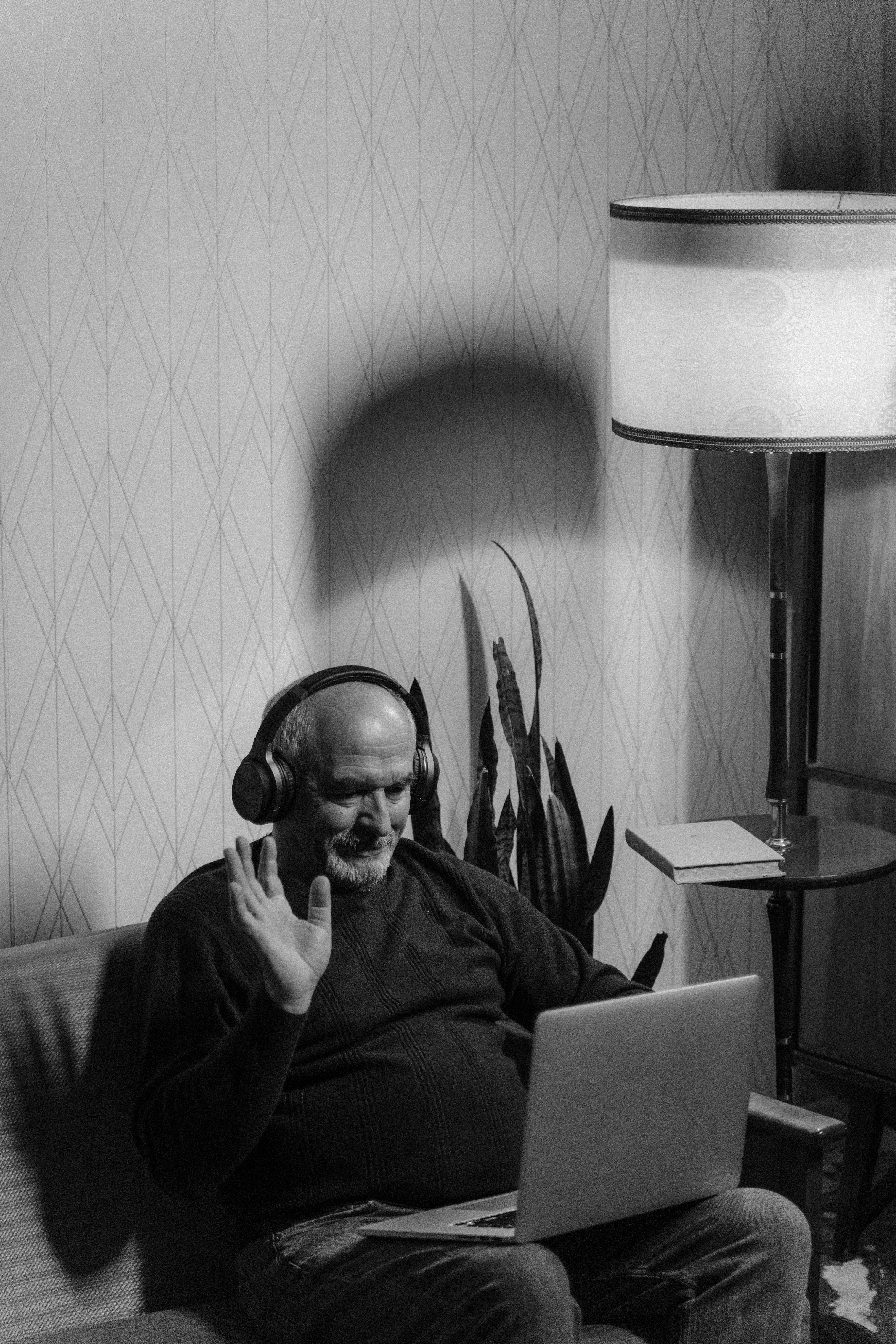 monochrome photograph of an elderly man wearing headphones