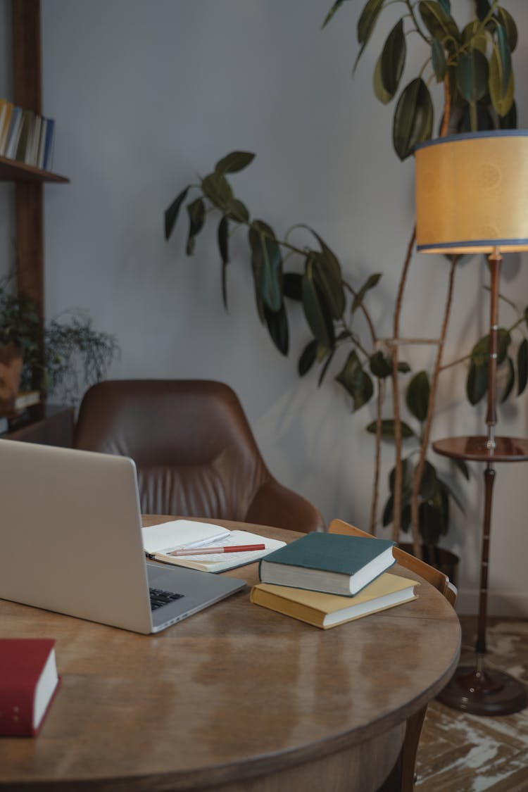 A Laptop And Books On The Table 