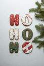 Ginger letter cookies composed with fir branch during Christmas holiday