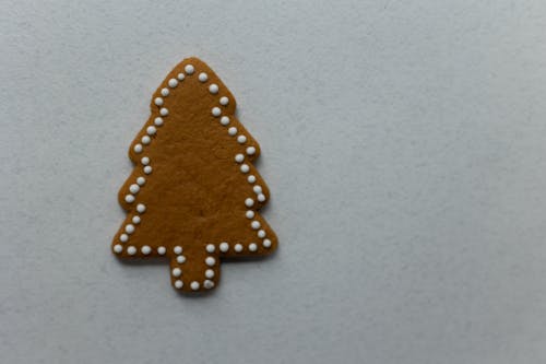 Tree shaped gingerbread placed on white background