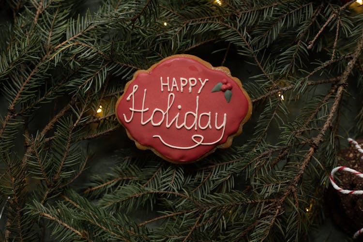 Happy Holiday Title On Christmas Cookie On Spruce Sprigs