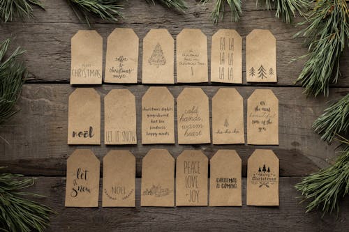 Collection of Christmas tags placed on wooden surface