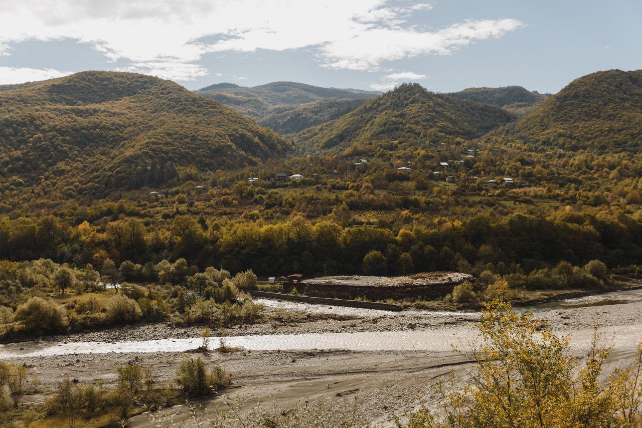 peaceful countryside landscape with hills and river in autumn showcasi