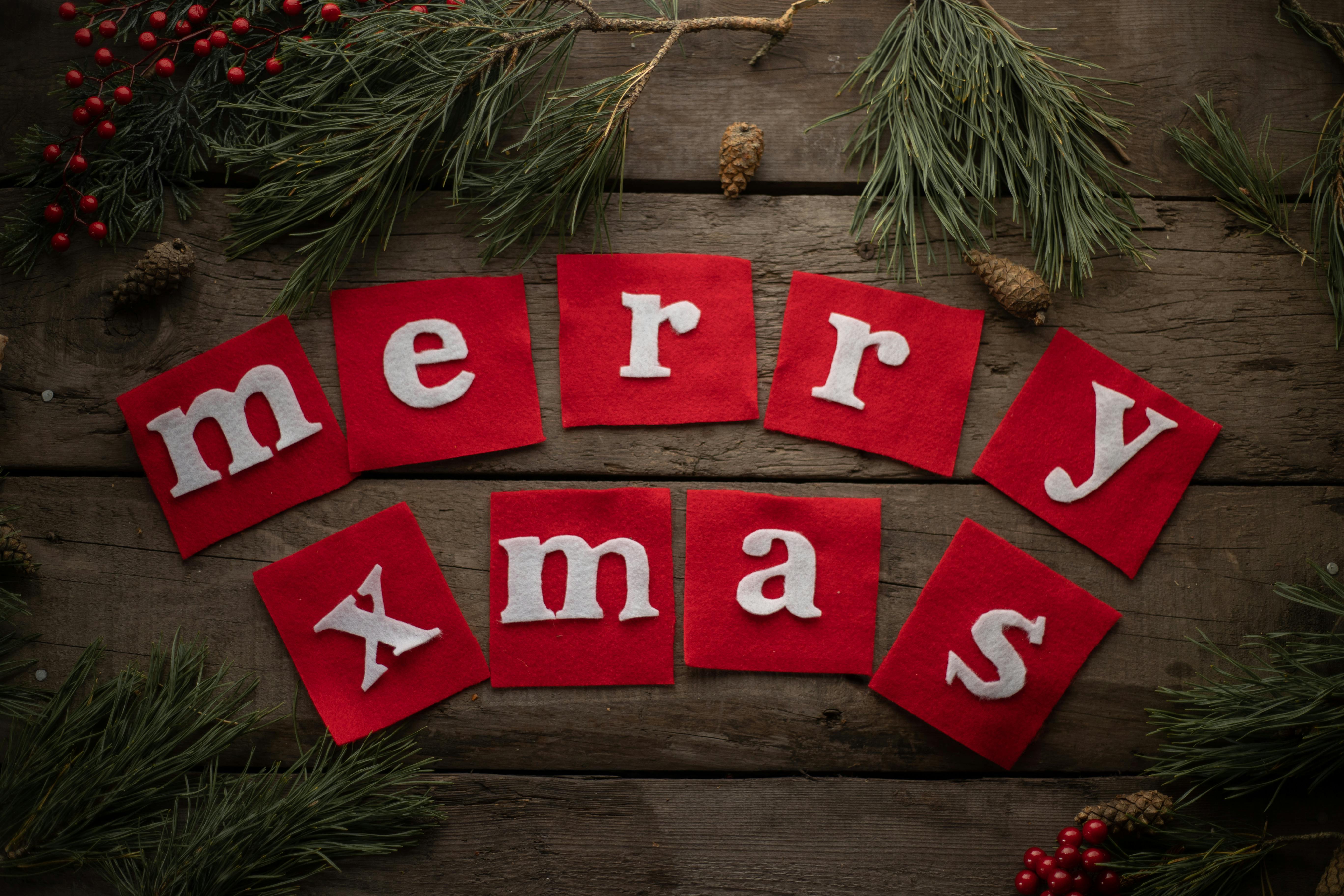 inscription merry xmas on wooden decorated background