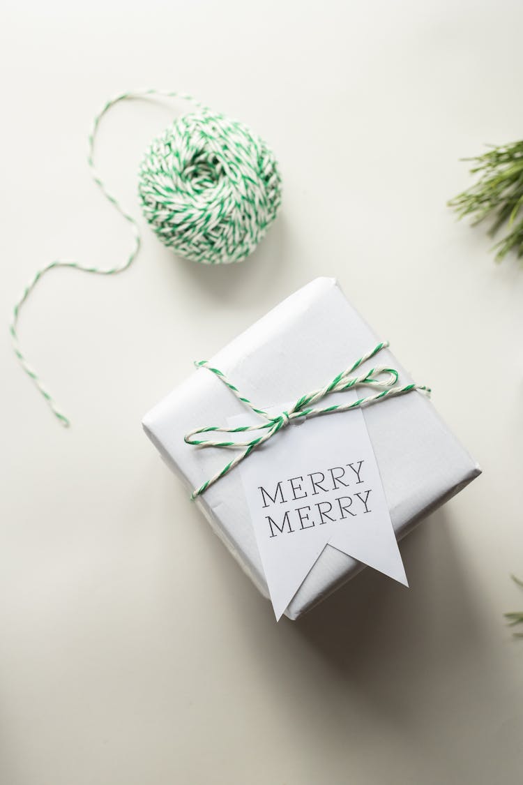 Arrangement Of Ball Of Wool And Wrapped Present On Table