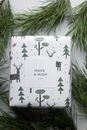 Handmade Christmas gift box with inscription among coniferous branches
