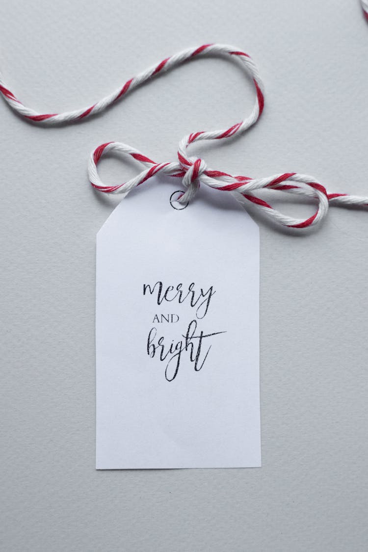 Present Tag With Red And White String Placed On White Background