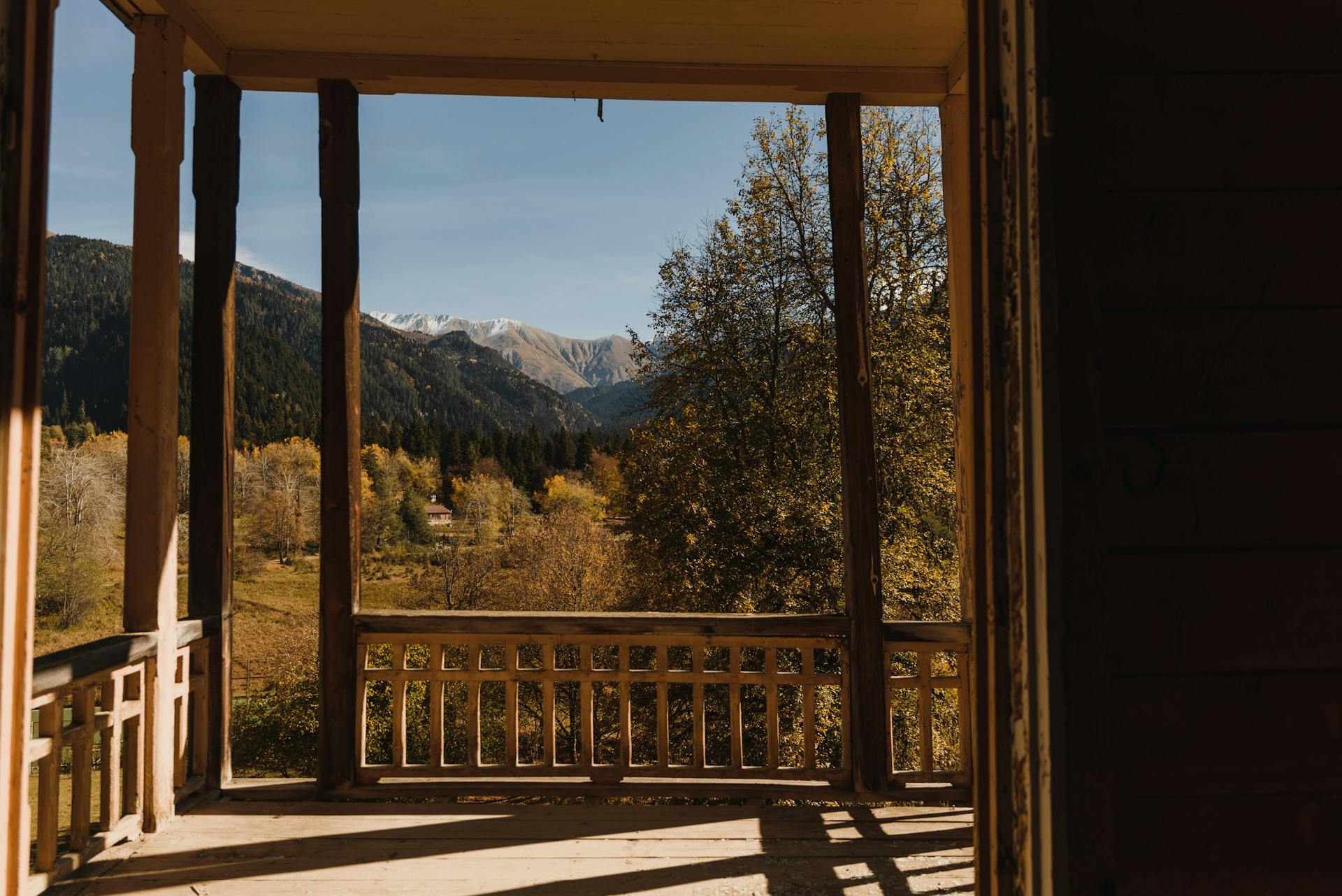 View on Autumn Forest in Mountains from Wooden Terrace