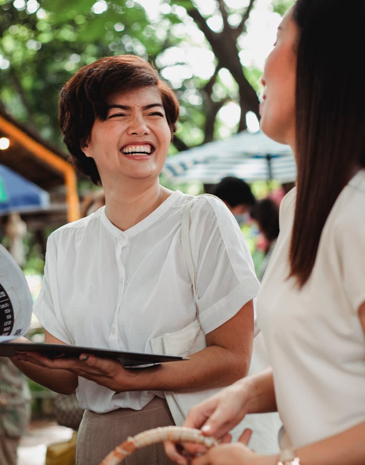 Laughing Asian Women Standing In Street Market