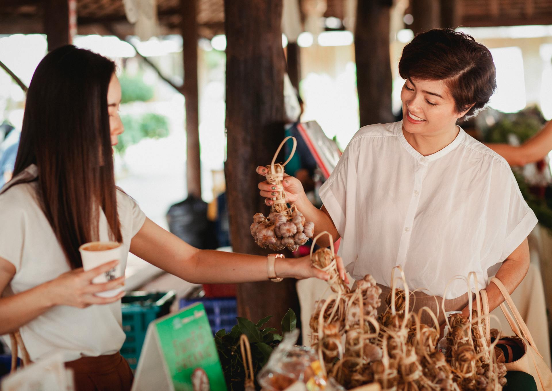 Ethnic women choosing ginseng at street market