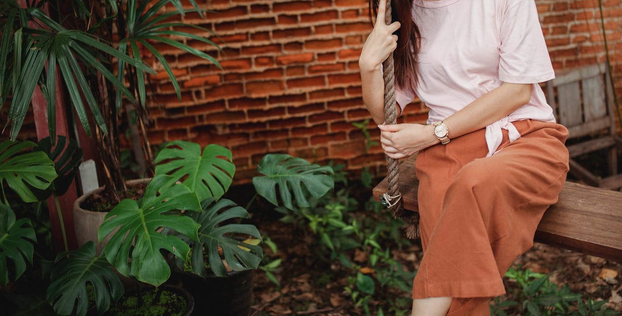 Free Stylish female sitting on swing Stock Photo