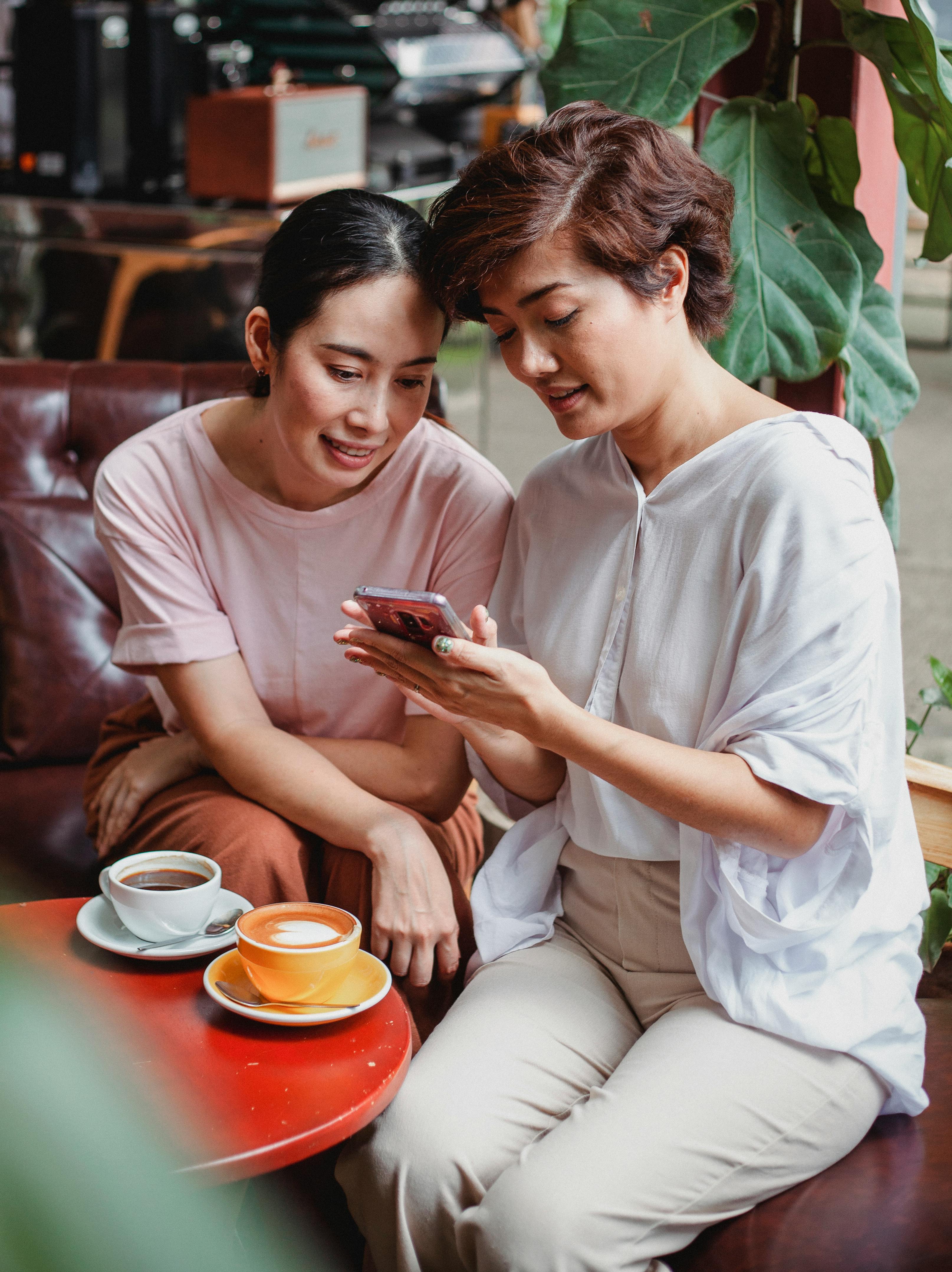 cheerful asian friends resting in cafe