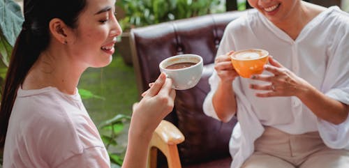 Free Women drinking hot beverages in cafe Stock Photo