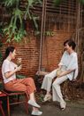 Happy Asian friends resting on terrace