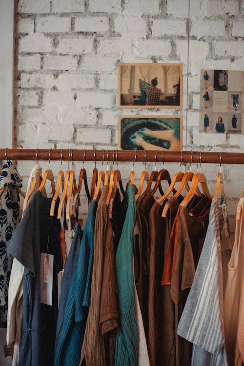 Different apparel on stand in clothing shop · Free Stock Photo
