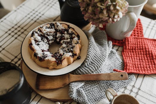 A delicious homemade berry cake served with coffee on a rustic table setup, ideal for cozy mornings.