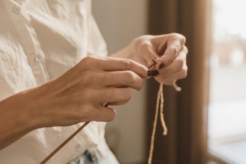 A Person Knitting 