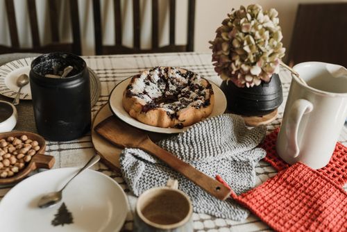 Free Cozy morning setup with a homemade pastry, coffee, and rustic decor on a wooden table. Stock Photo
