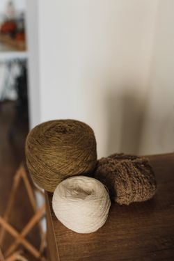Natural yarn rolls in earthy tones, by Arina Krasnikova on Pexels