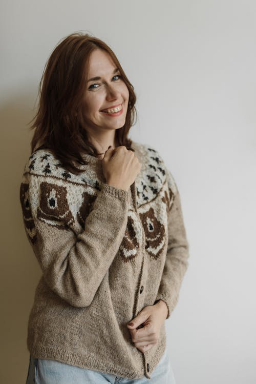 Smiling Woman Wearing a Knitted Cardigan