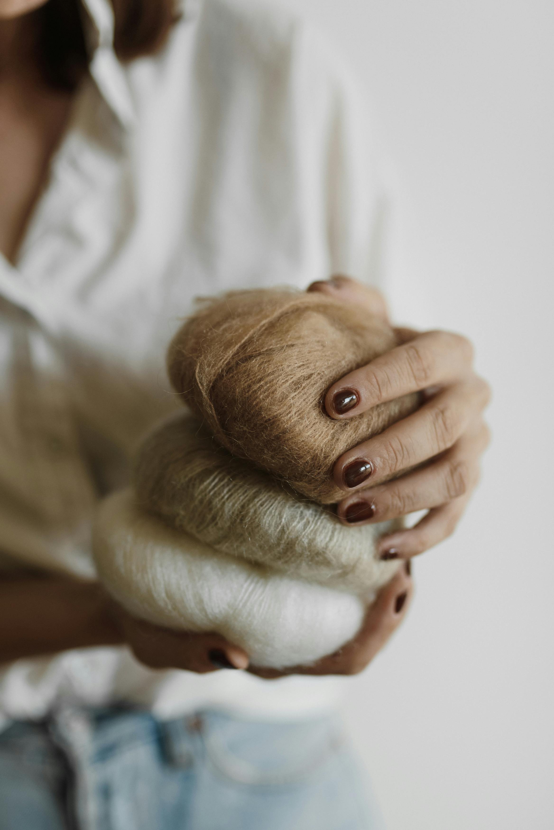 person in white shirt covering face with hands